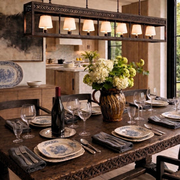 Antique French blue and white tableware styled on a rustic dining table in an elegant modern kitchen.