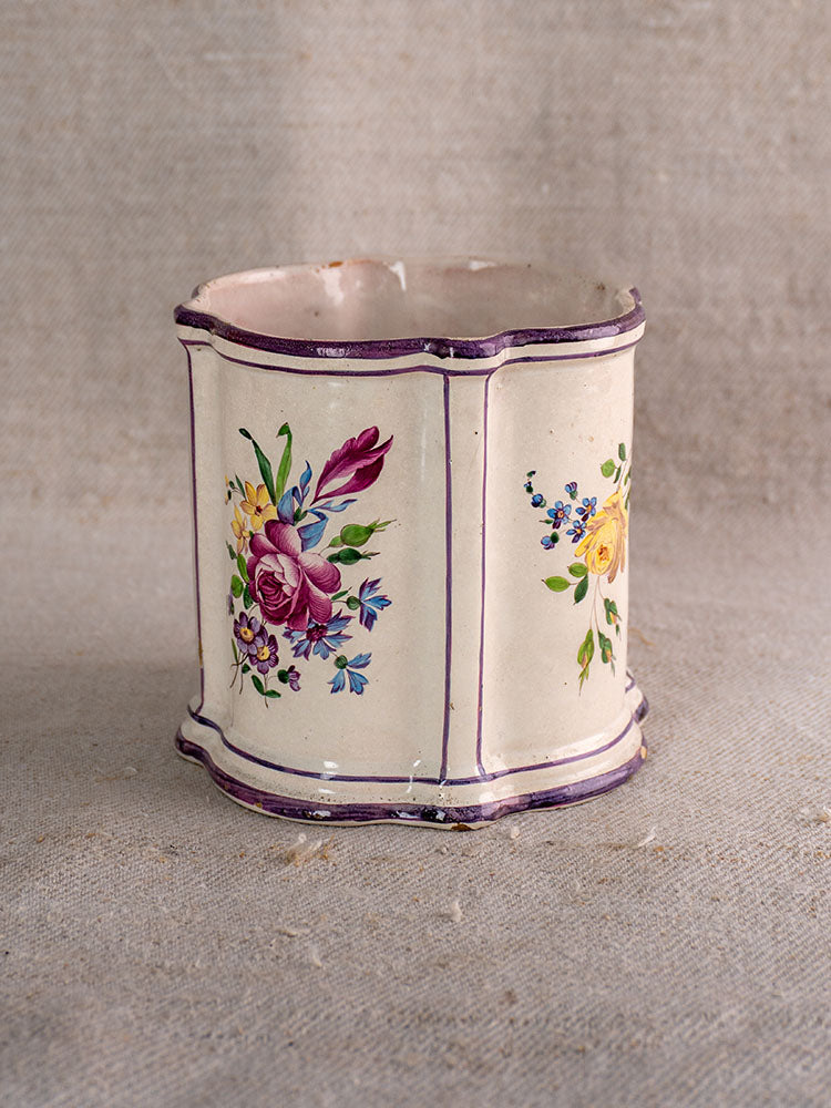 Antique French faience cache pot, hexagonal cream ceramic with hand-painted Chinoiserie florals and purple trim on beige fabric.