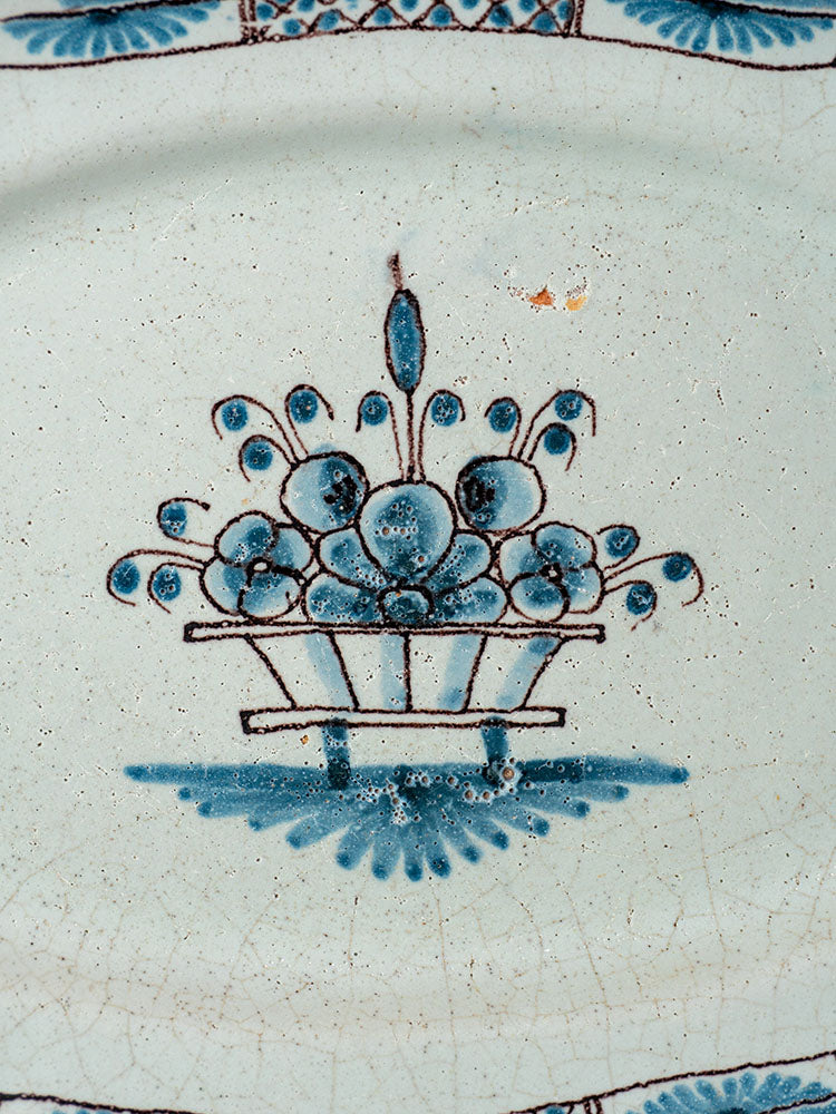 Antique French faience platter, Rouen Cul Noir style, blue stylized flowers on crackled white ceramic glaze.