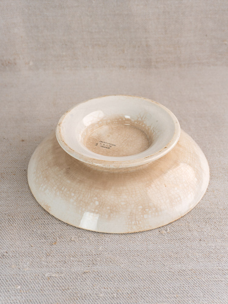Antique French faience plate set, Trebeurden pattern by HBCM Creil Montereau, with crackled glaze on beige textured fabric.