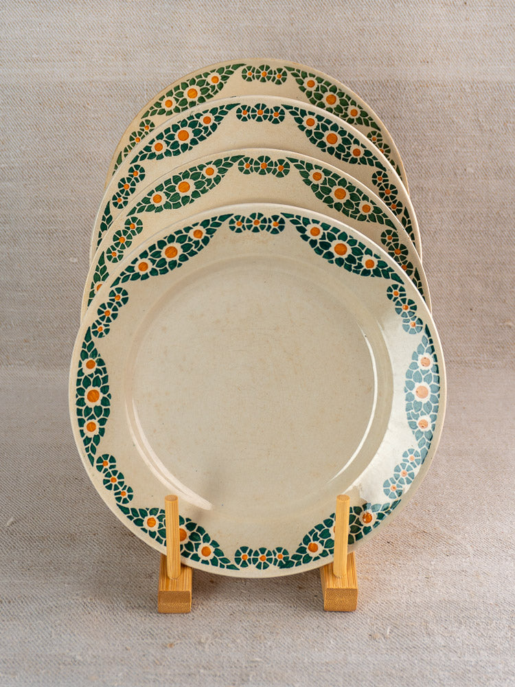 Set of four antique French faience plates by HBCM Creil Montereau with Trebeurden green and orange geometric borders.