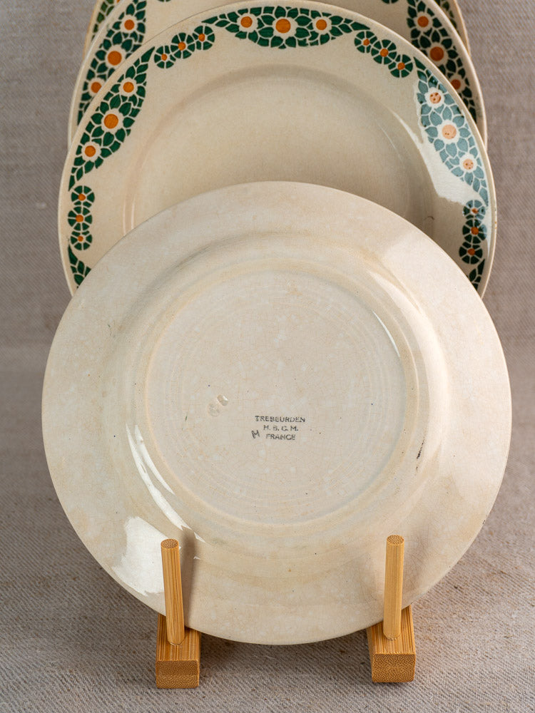 Antique French faience plates, Trebeurden pattern by HBCM Creil Montereau, on wooden stand.