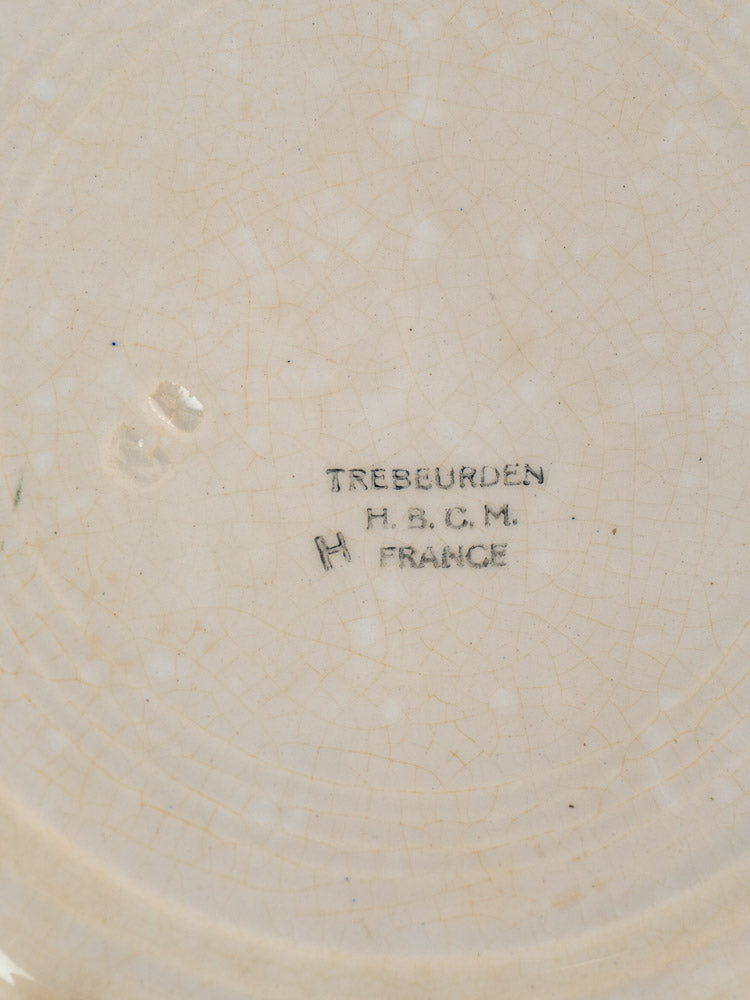 Antique French faience plate underside with TREBURDEN HBCM maker’s mark on crazed cream-glazed ceramic.