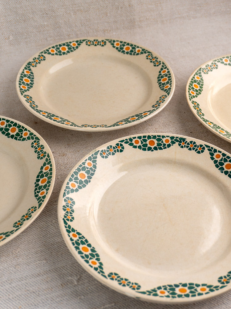 Set of four antique French faience plates by HBCM Creil Montereau, Trebeurden pattern with green and orange floral border.
