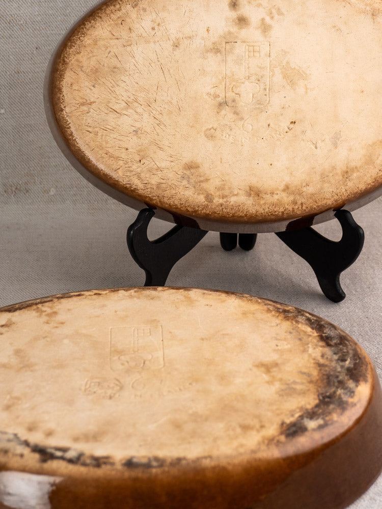 Pair of vintage French La Bourguignonne stoneware gratin dishes with faint embossed logos.