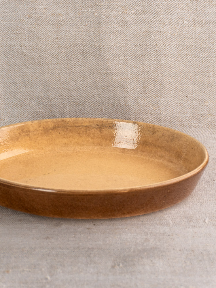 Pair of vintage French La Bourguignonne stoneware gratin dishes with earthy brown glaze on light gray textured surface.