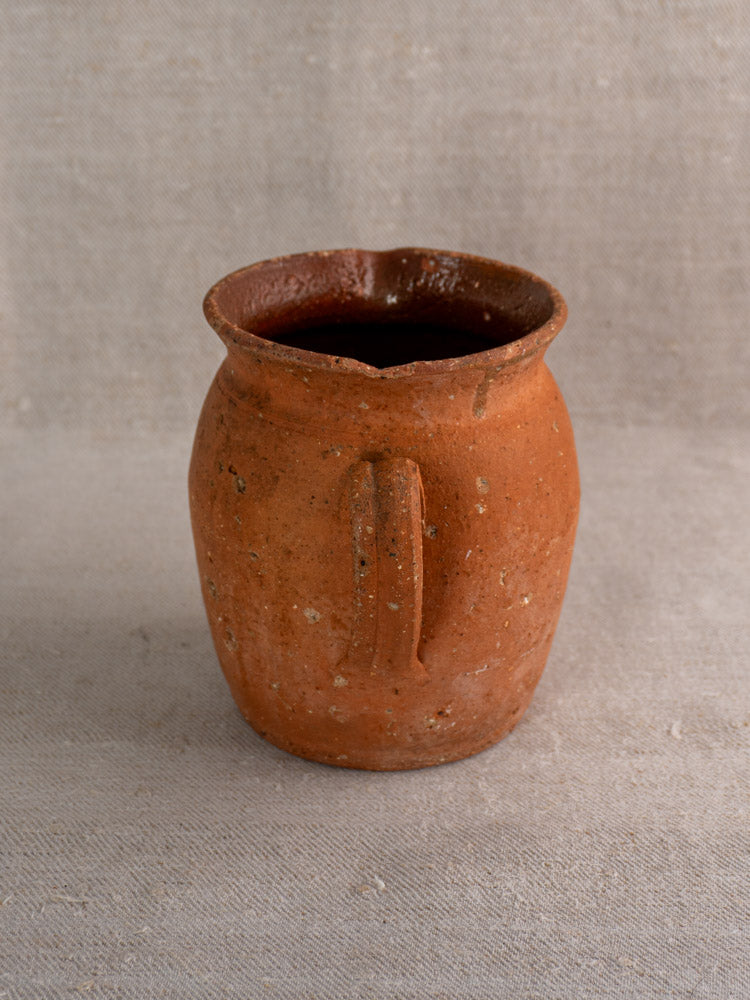 Antique French terracotta pitcher, mid-19th century, pinched lip, rustic brown clay, single handle, handmade appearance.