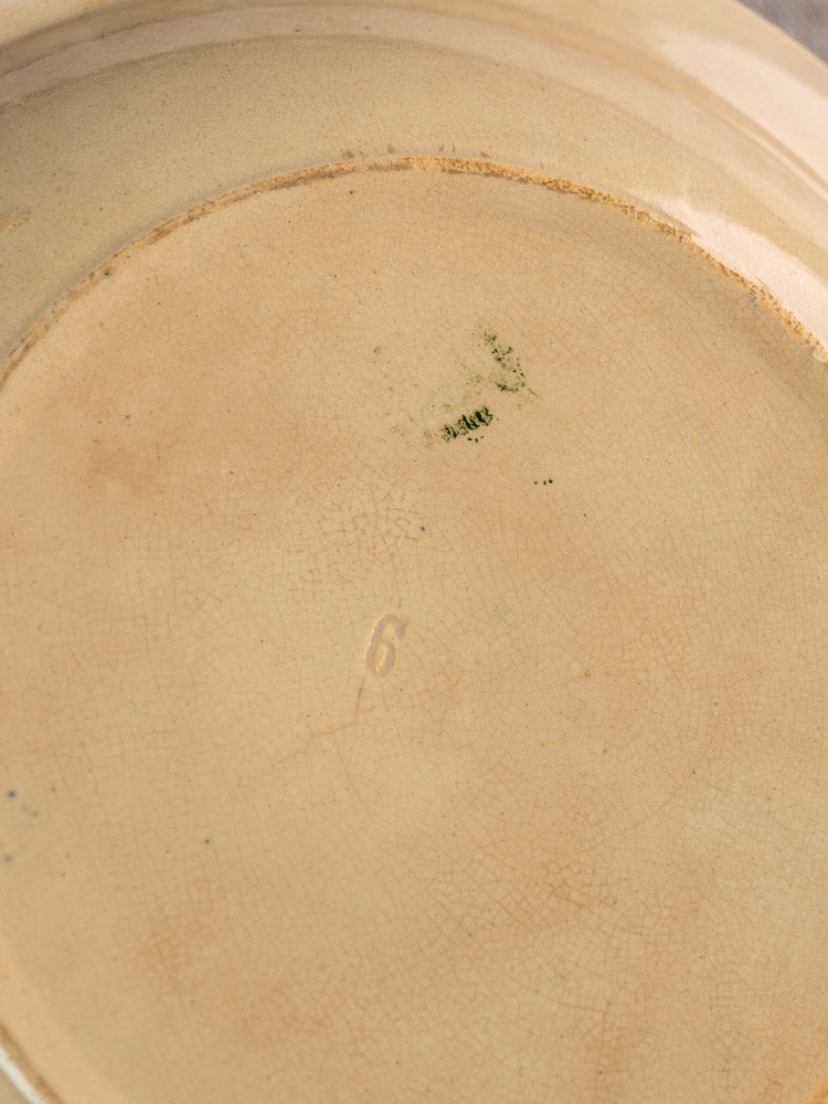Underside of antique French Grigny Terre de Fer saladier with beige crackled ceramic, green stamp, and embossed 6.