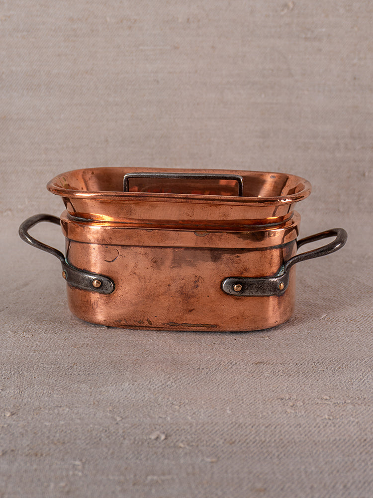 Antique French copper daubiere set with two metal handles, lid, and gently worn 19th-century patina.