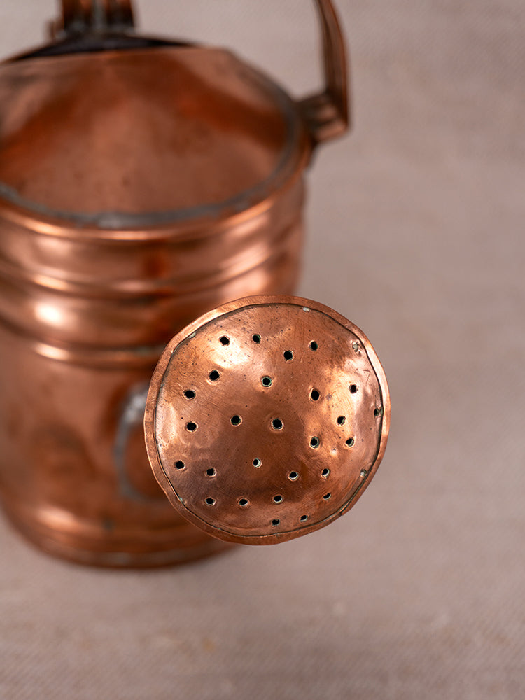 Antique French copper watering can spout with round, perforated rose and riveted detail, late 1800s.