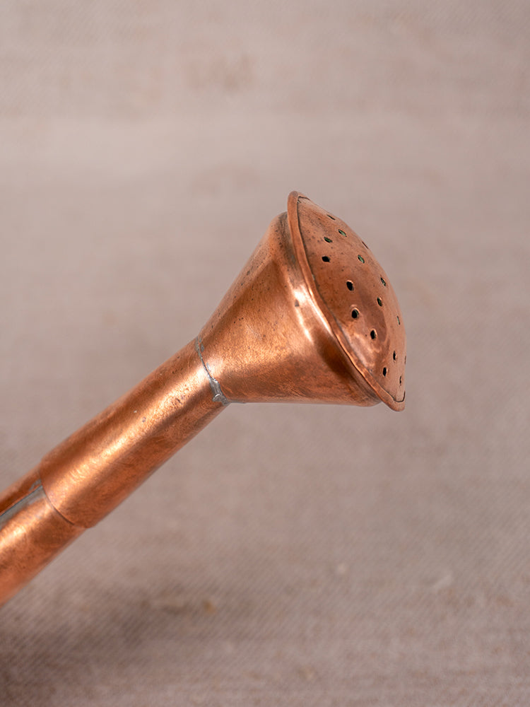 Antique French copper watering can spout with riveted detail and round, perforated rose for gentle watering.