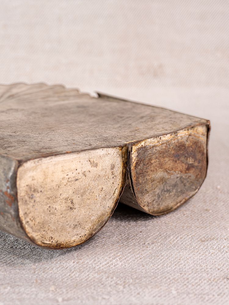 Provençal wall mounted utensil holder in aged steel with two rounded sections and a tarnished finish on fabric.