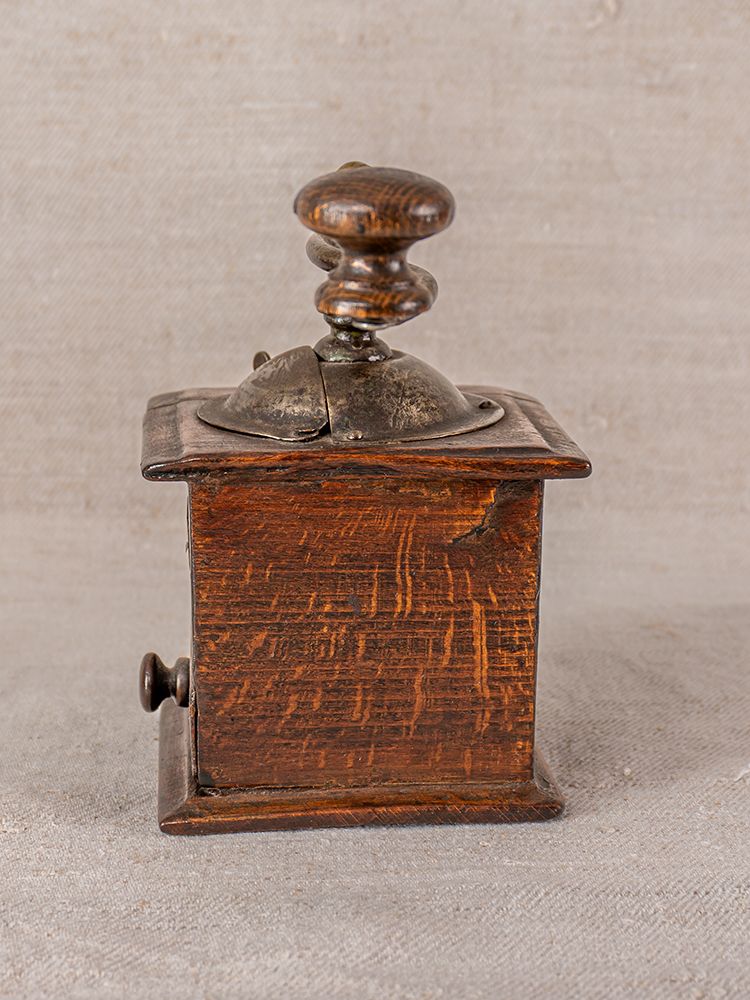 Antique French Peugeot Frères coffee grinder with metal crank, dark oak, late 19th century, showing age and wear.