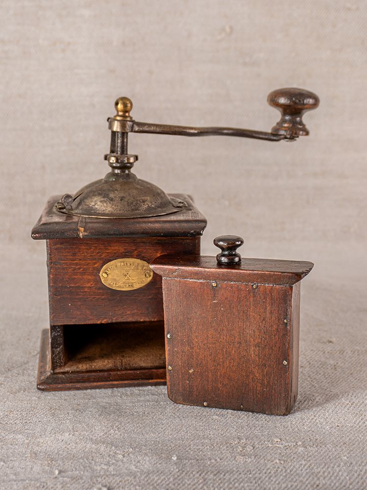 Late 19th-century Peugeot Frères French coffee grinder in wood and metal, open drawer revealing ground coffee compartment.