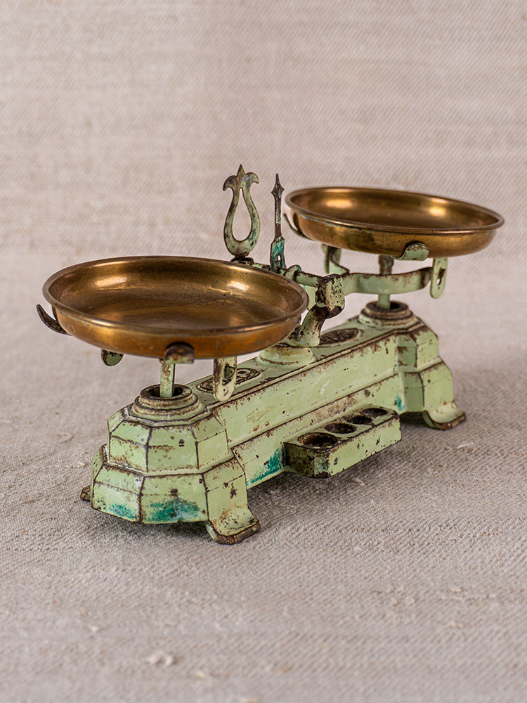 Vintage French JEP toy balance scale in green cast iron with brass plates, gently aged patina.