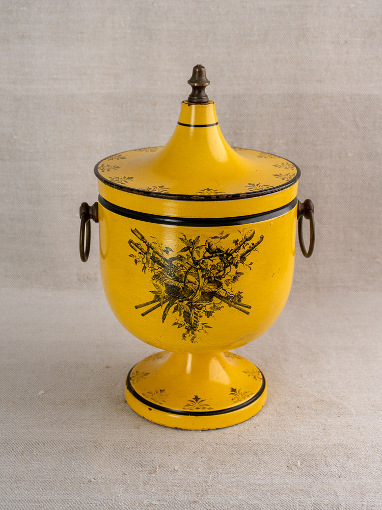 Vintage French yellow Directoire tôle peinte champagne cooler with lid, black floral motif, and metal handles.