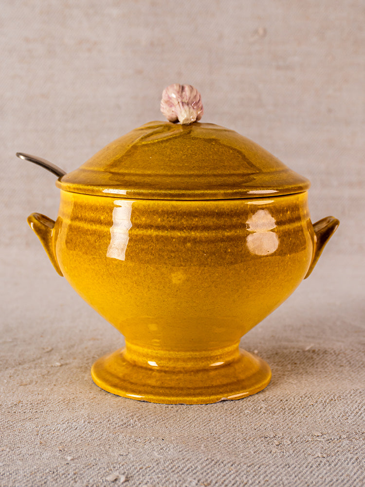 Signed Eyguières Provençal yellow glazed earthenware tureen with lid and handles, shown with metal ladle.