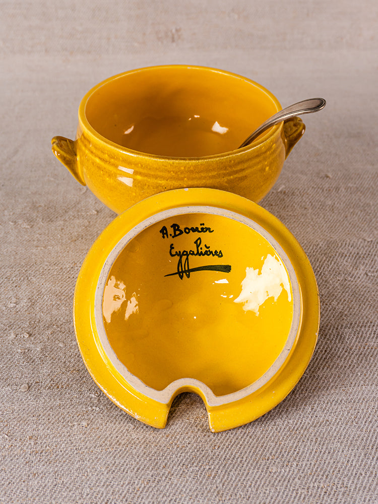 Vintage French glazed yellow soupière tureen with handles, spoon, and signed lidded top.