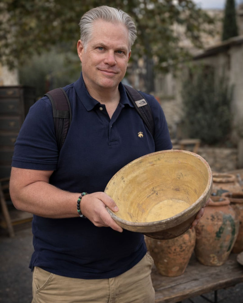 Scott Groth holding a piece of antique French pottery