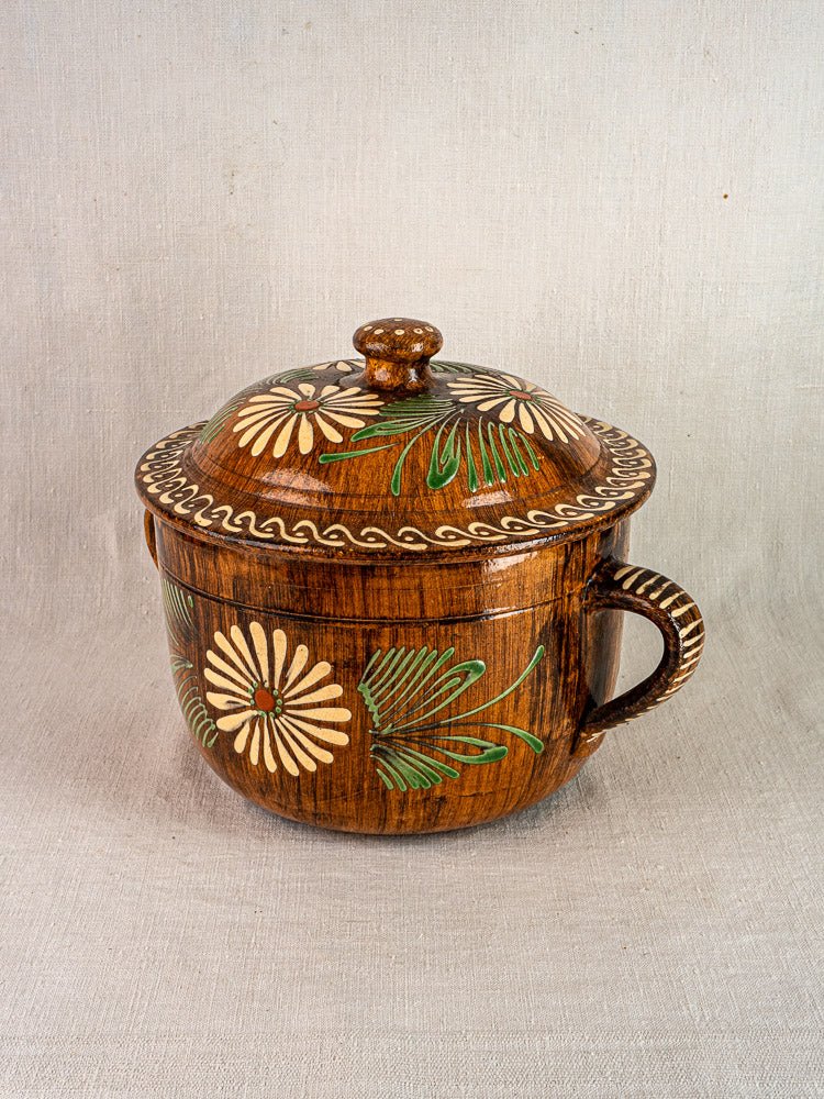 Alsace glazed terracotta pot with lid and single handle, white and green floral slip decoration.