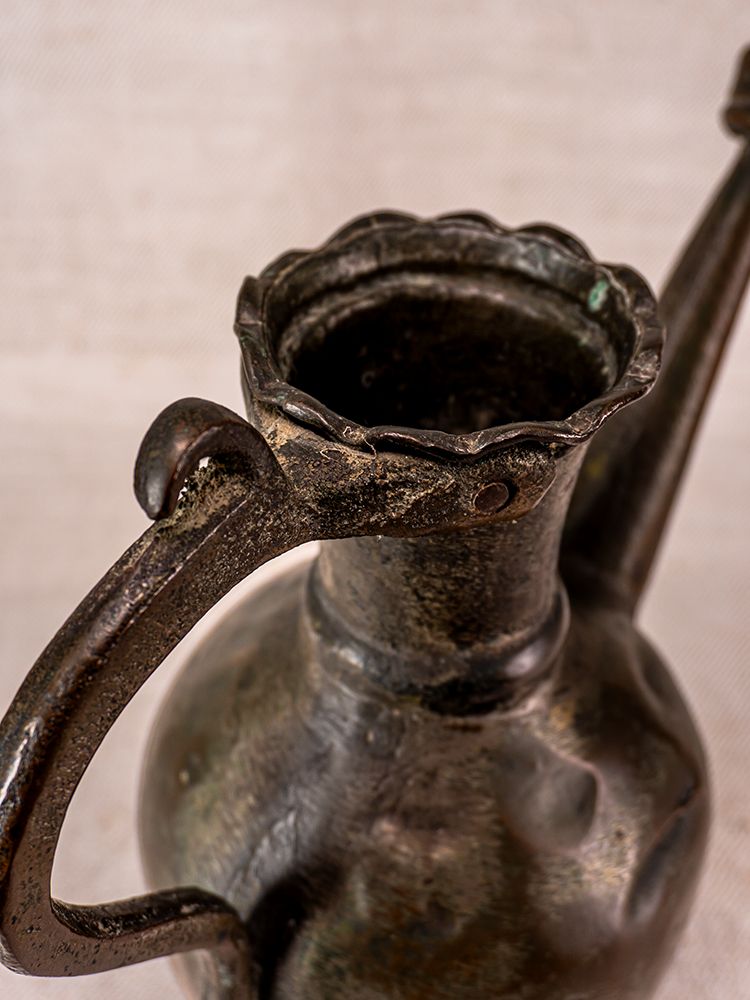 Antique Anatolian tinned copper ibrik watering can, 19th century, with scalloped rim, curved handle, and aged patina.