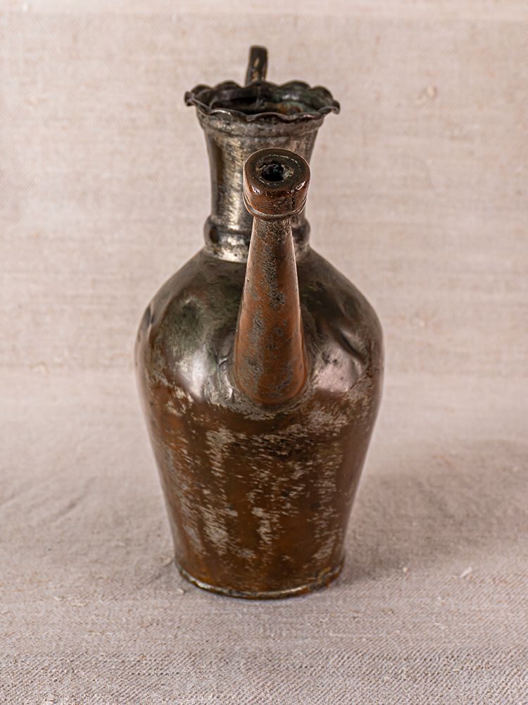 19th-century Anatolian tinned copper Ibrik watering can with long spout and scalloped rim on beige background.