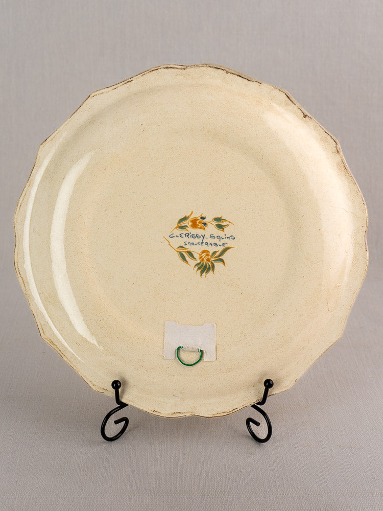 Vintage French Salins Clérissy faience plate with scalloped edges, floral motif, and handwritten reverse.