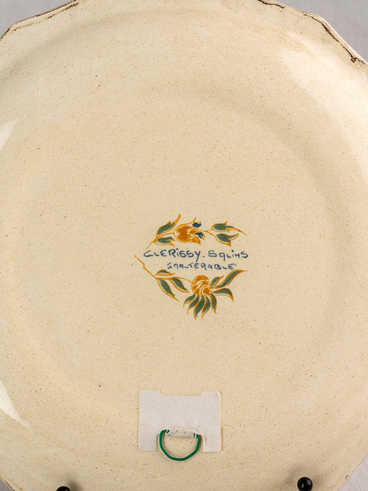 Back of vintage French Salins faience plate with hand-painted motif, handwritten script, metal hanger, and padded square.