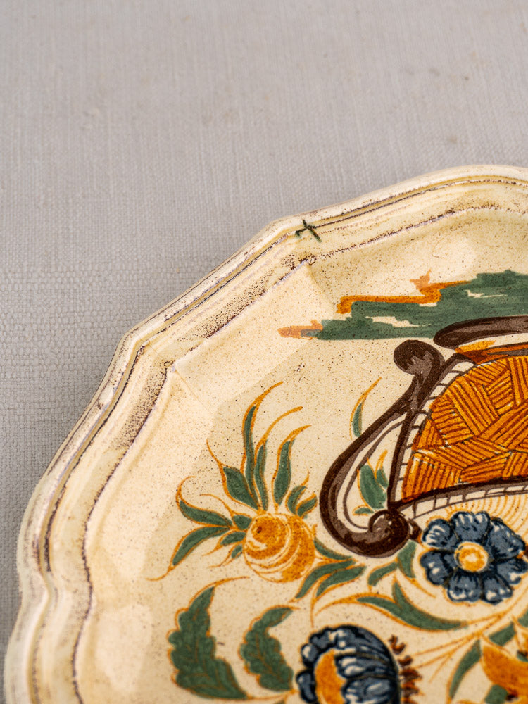 Vintage French Salins Clérissy faience plate with hand-painted Moustiers floral motifs and scalloped rim.