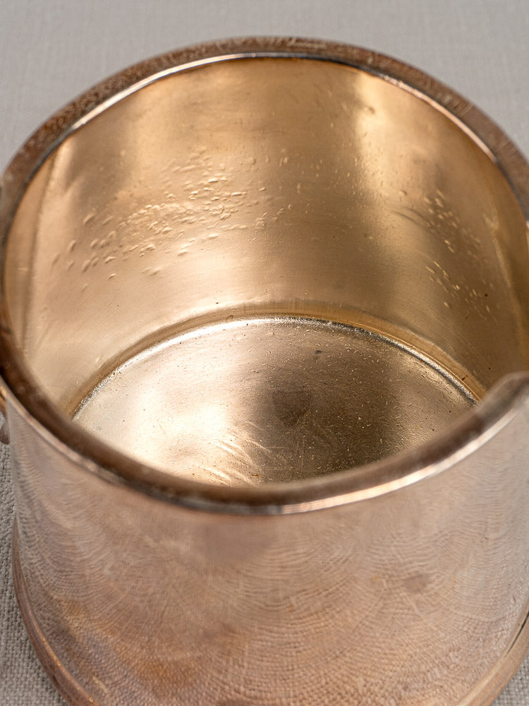 Antique English silver plate milk jug by Walker & Hall, 1900, copper with subtle tarnish on a light textured surface.