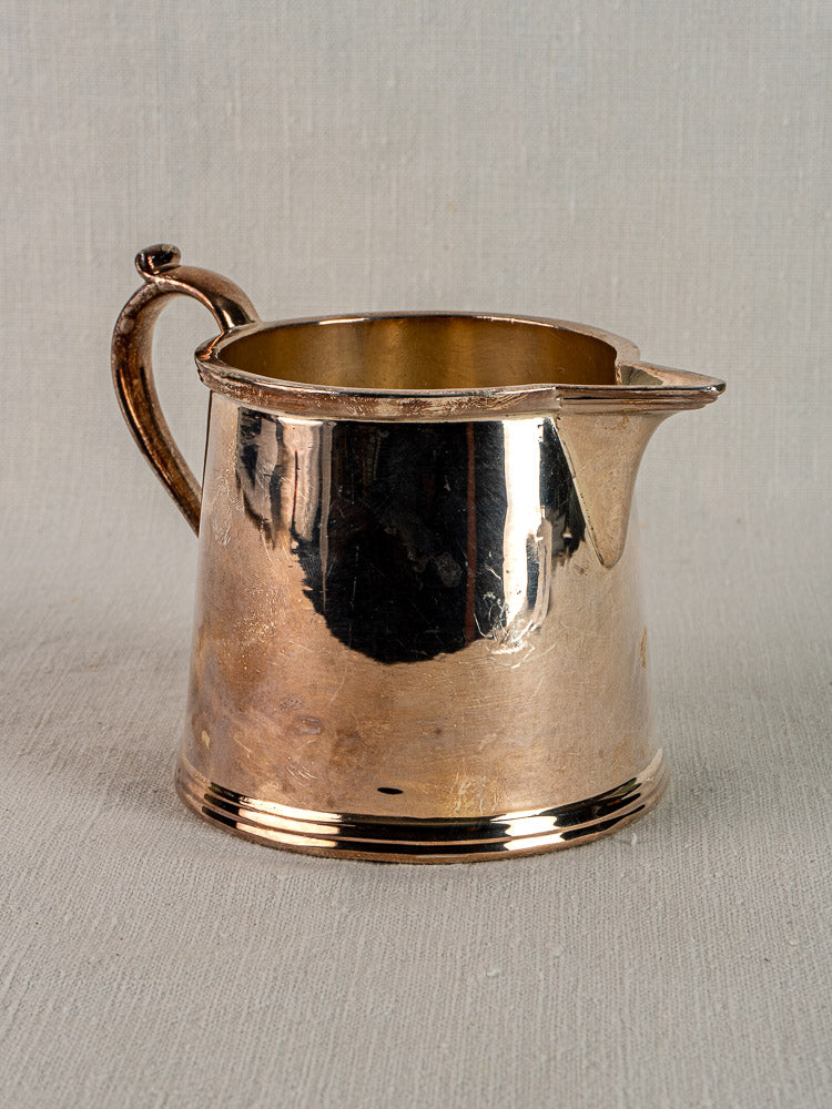 Antique English silver plate milk jug by Walker & Hall Sheffield, circa 1900, with curved handle on textured surface.