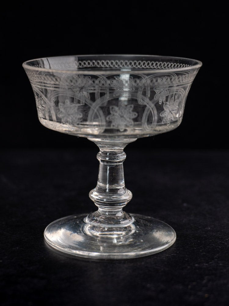 Set of six antique French uranium glass coupes, circa 1900, with etched floral patterns.