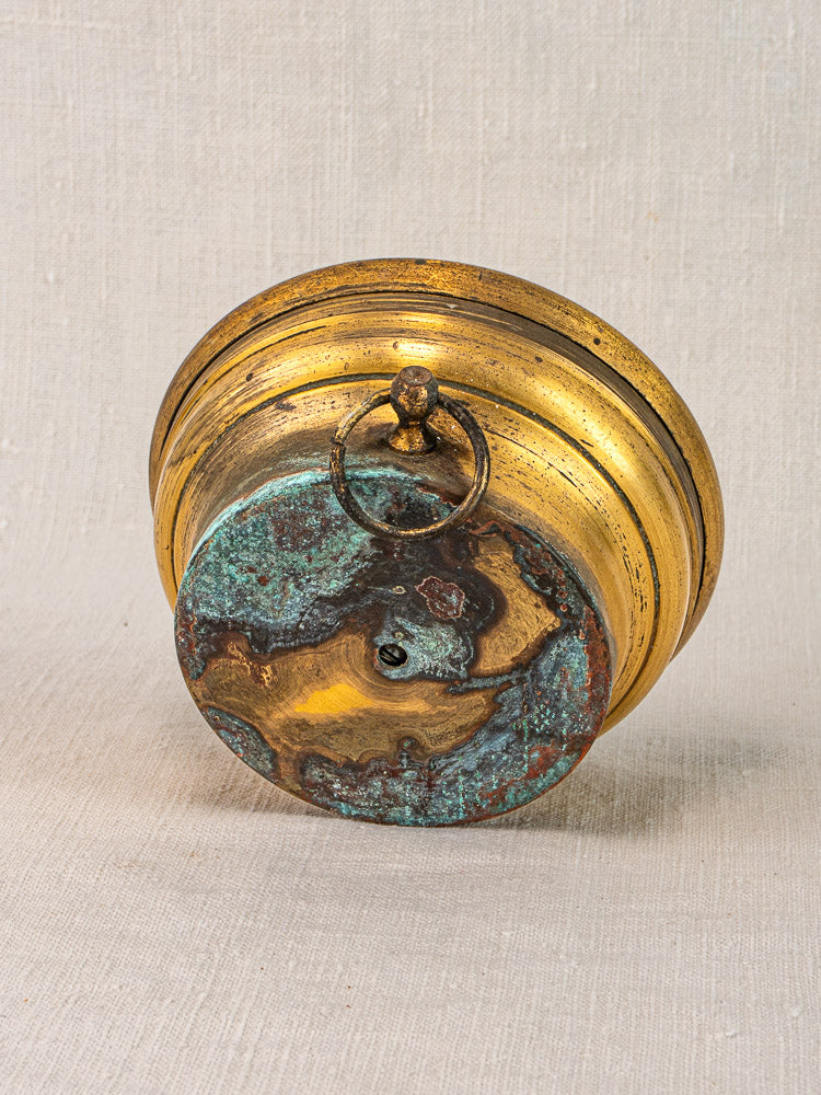 Antique Jules Richard Paris French barometer, round gold-toned brass case, patina base, on neutral fabric background.