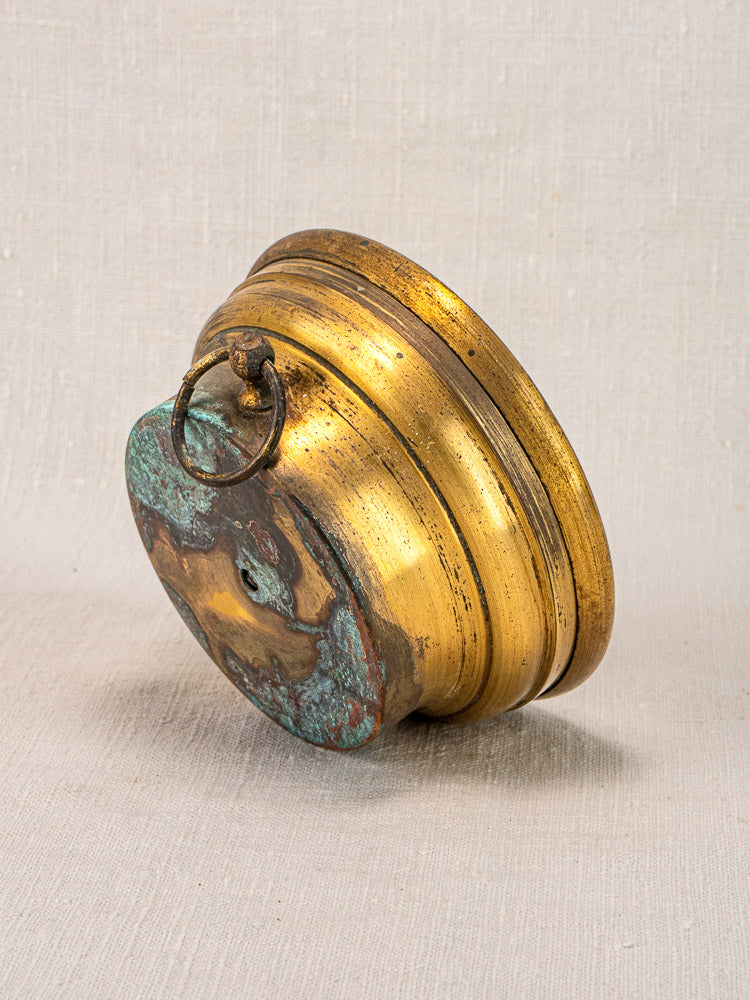 Antique French barometer by Jules Richard Paris with golden brass case and green patina on textured fabric background.