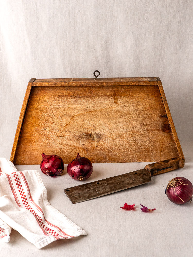 Antique French beech cutting board, late 19th century, styled with red onions and vintage cleaver.