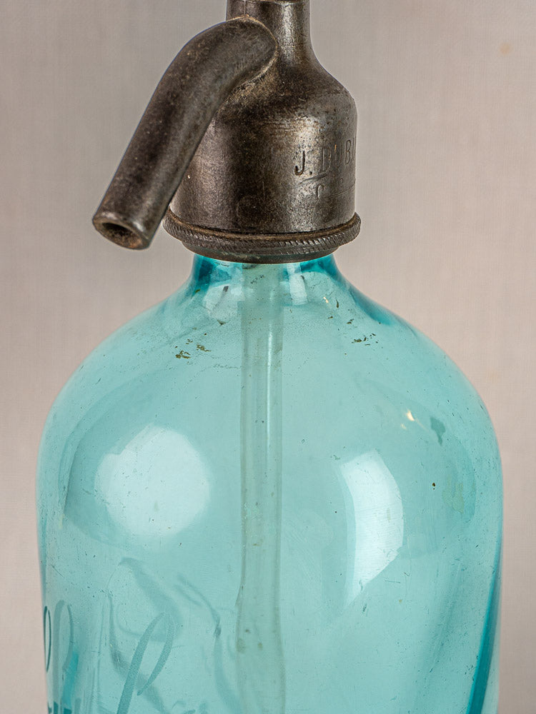 J. Dubuche antique French bistro seltzer bottle with vintage blue glass and metal siphon top.