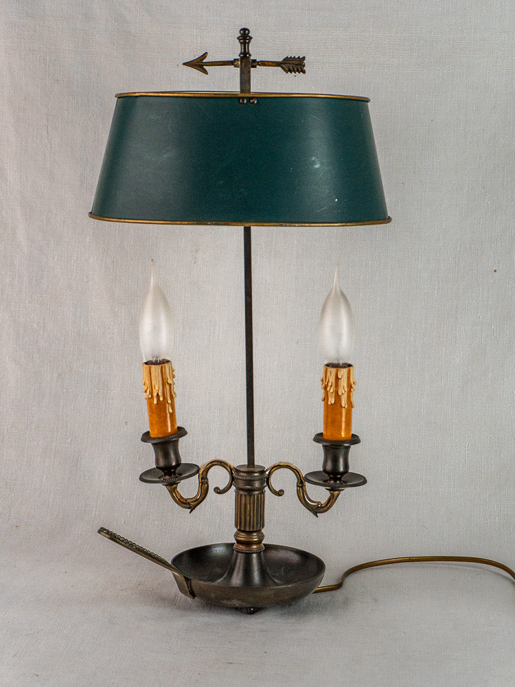 French Bouillotte lamp with green tôle shade, two arms, candle-style bulbs, and arrow finial.