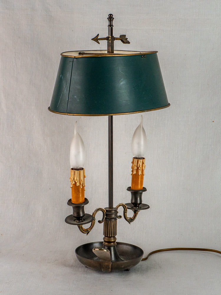 French Bouillotte lamp with vintage green tole shade, Louis XVI style, arrow finial, neutral background.