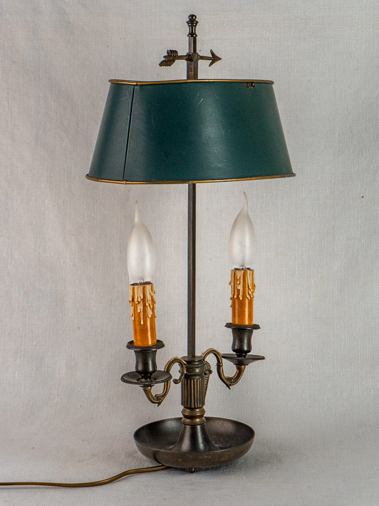 French Bouillotte lamp with vintage dark green tôle shade, arrow finial, and candle-style bulbs.