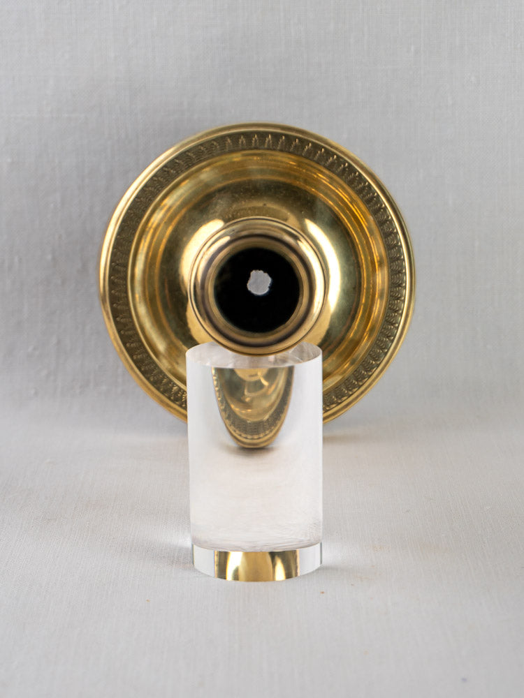 Empire Palmette Brass Candlestick | Antique French Bougeoir with clear cylindrical object, on light gray background.
