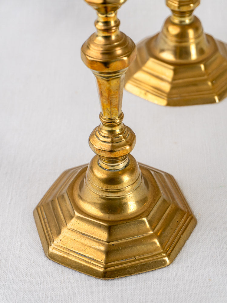 Antique French Louis XV brass candlesticks, ornate octagonal bases, minor age-related discoloration.