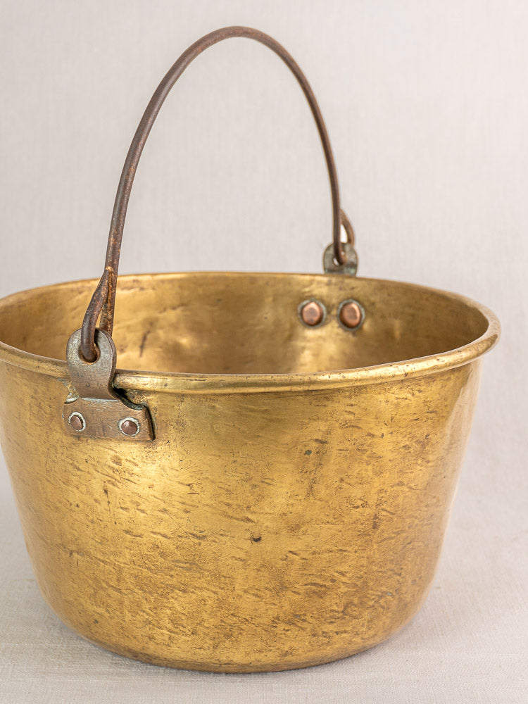 Antique French brass jam pan, early 19th century, tarnished finish with sturdy metal handle.