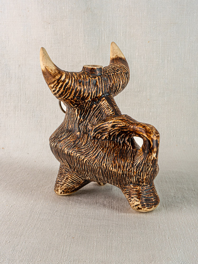 Ceramic vintage French bull zoomorphic pitcher, circa 1950, brown and tan glazed, neutral fabric background.