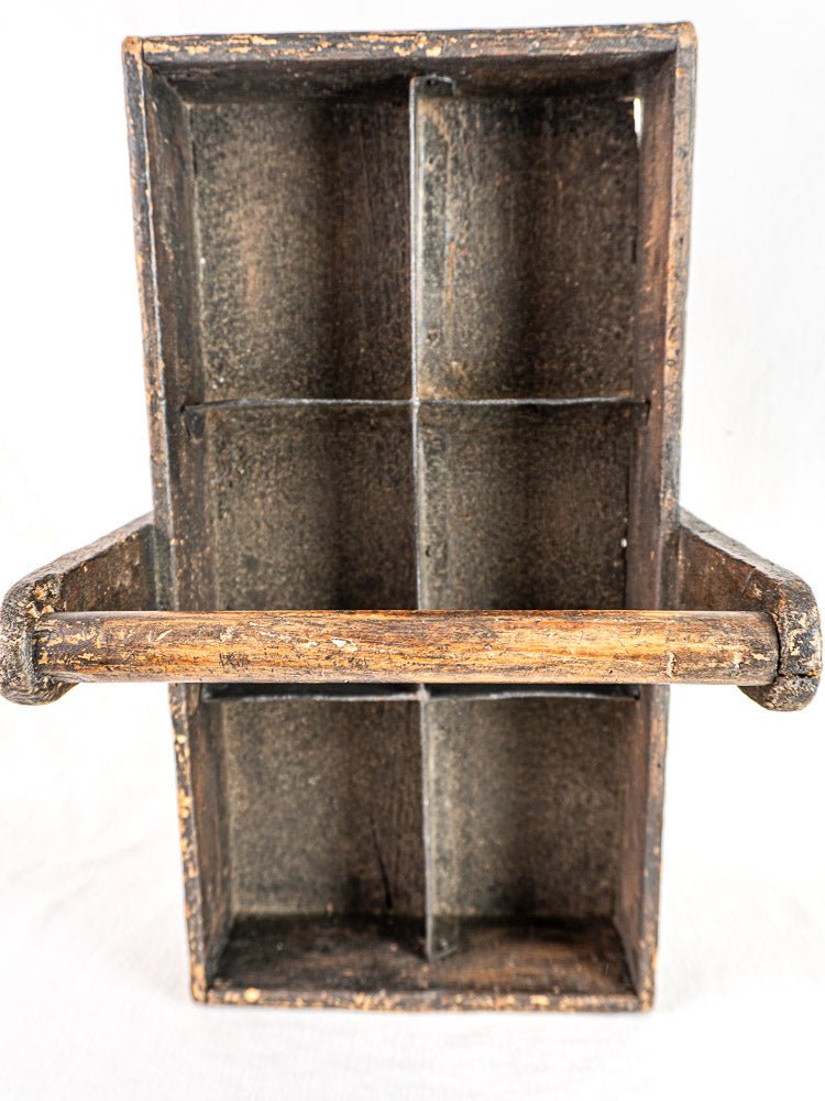 Antique French oak carpenter caddy with six compartments, hand-forged nails, and a central handle.