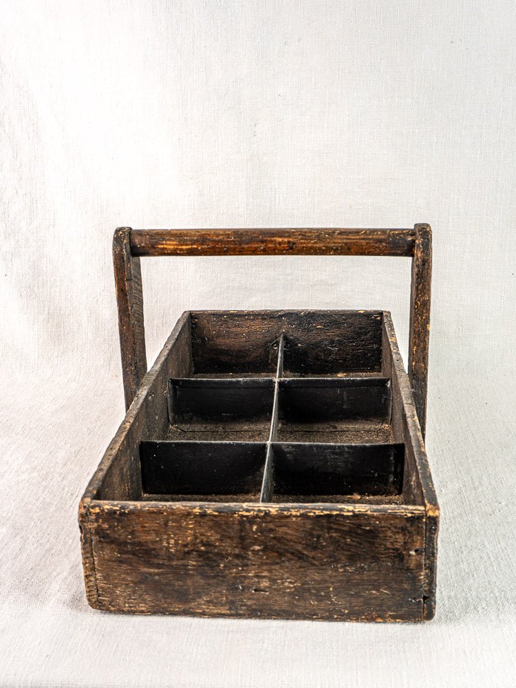 Antique French oak tool tote with hand-forged nails, six compartments, and a sturdy handle.