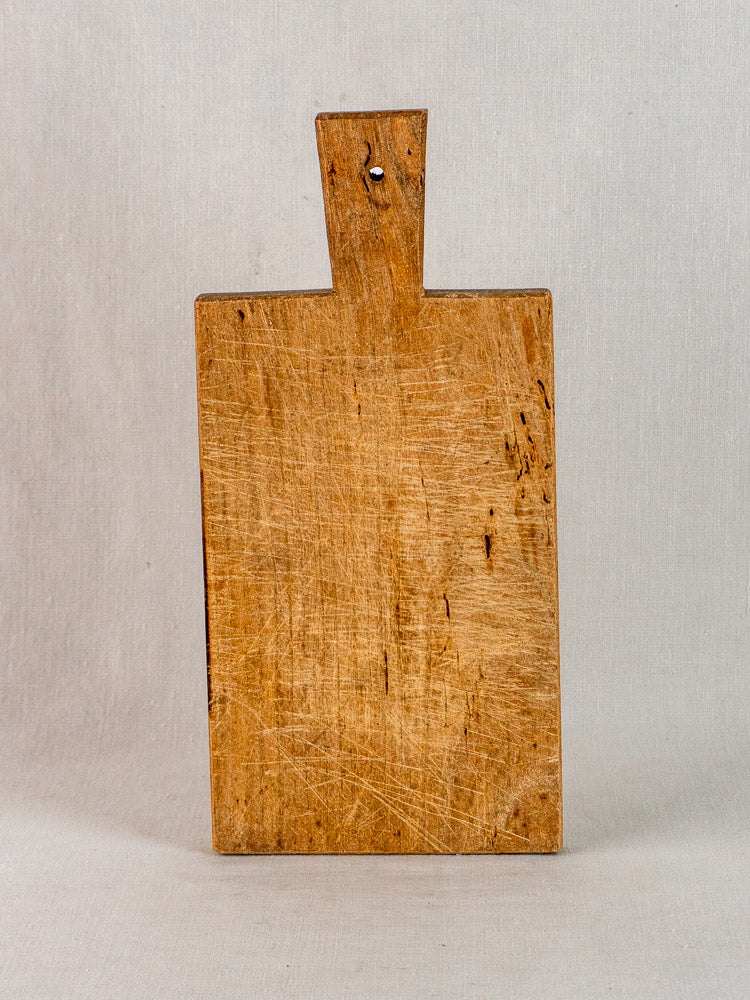 Antique French hardwood cutting board, hand-cut with aged surface and visible 19th-century wear.