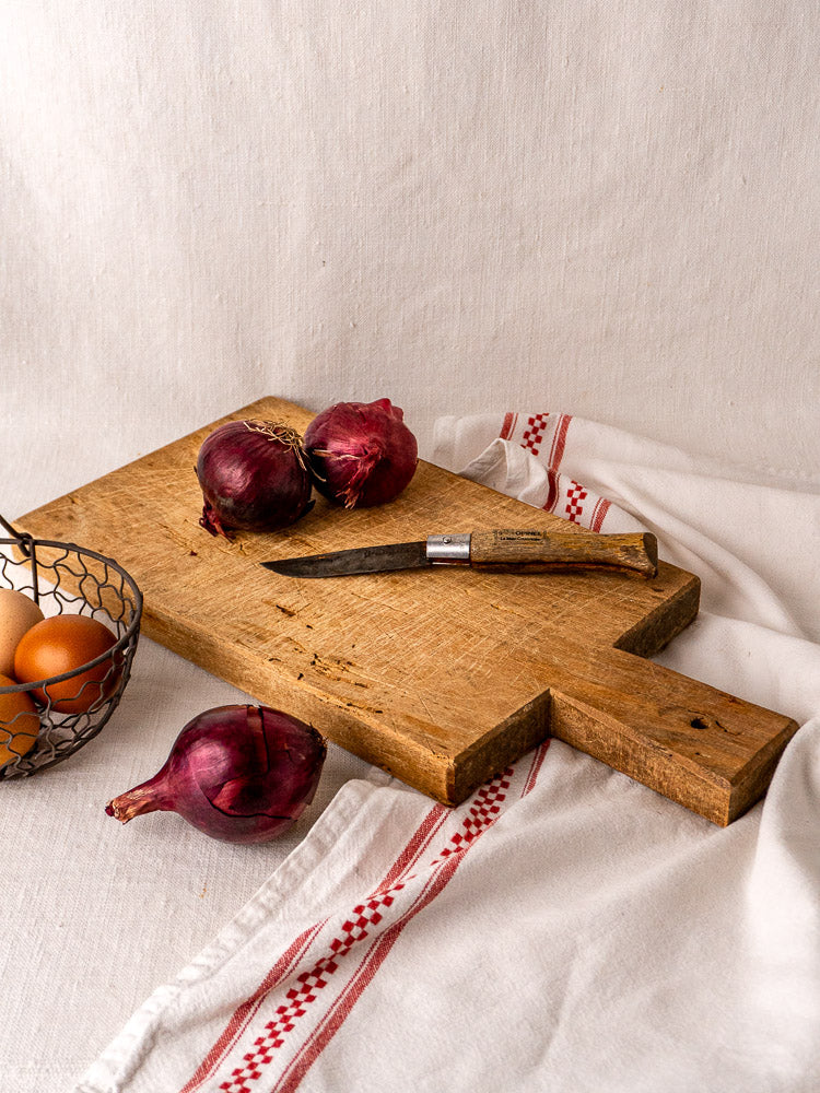 Antique French hardwood cutting board, hand-cut with aged surface and visible 19th-century wear.