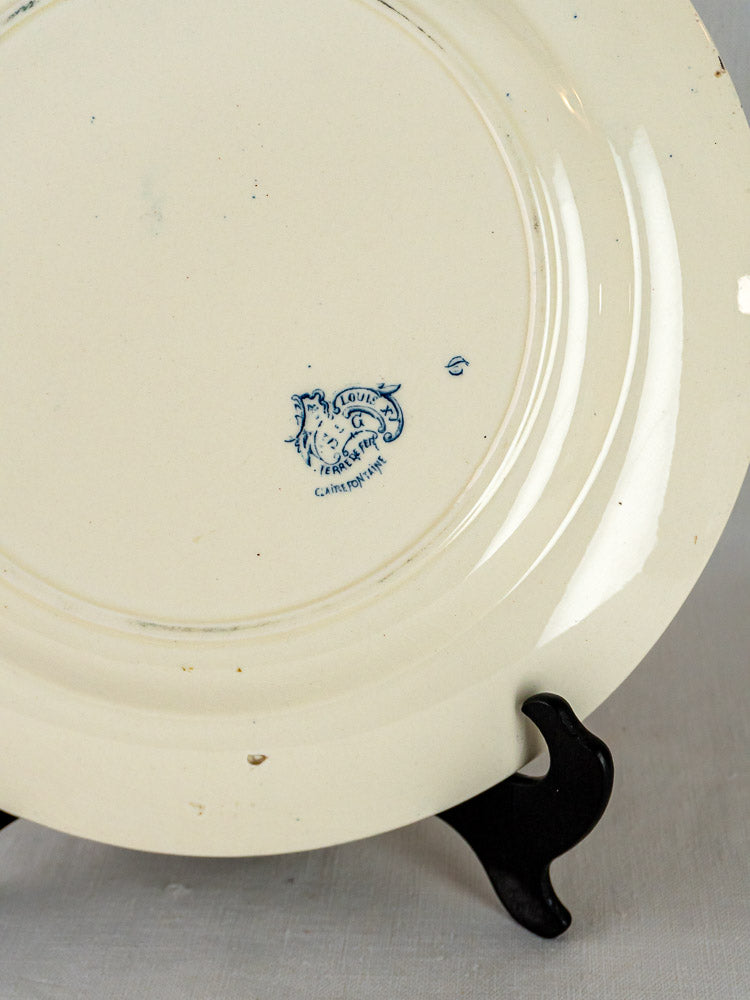 Clairefontaine Louis XV antique French terre de fer platter back with blue lion maker’s mark displayed on black stand.