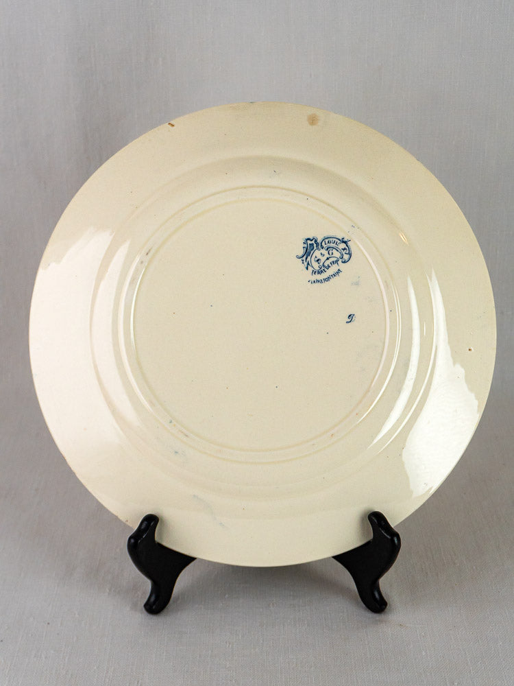 Vintage cream ceramic Clairefontaine Louis XV terre de fer plate showing blue maker’s mark and light stains.