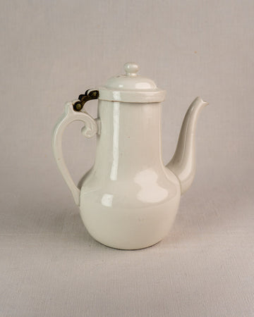 French Limoges Frugier aluminite porcelain coffee pot with curved spout, ornate handle, and hinged lid.